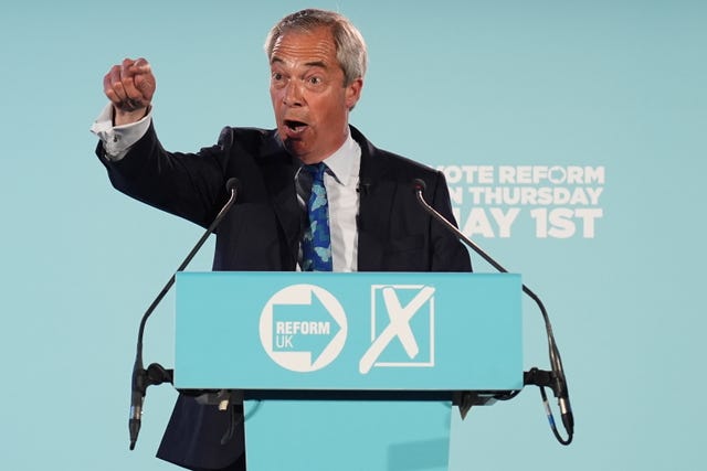 Nigel Farage points into the crowd as he speaks at a Reform UK rally