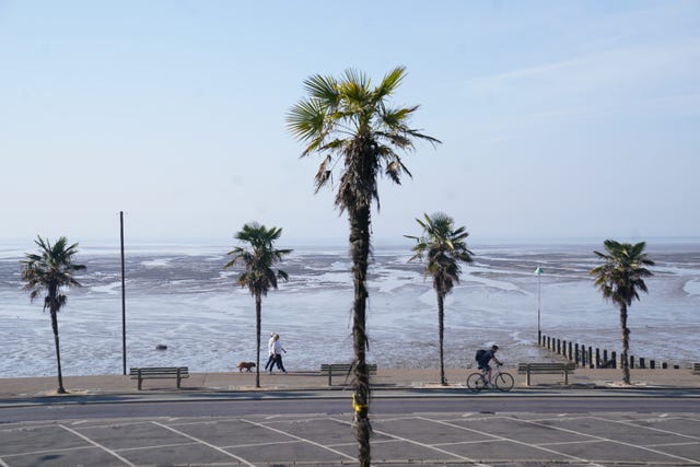 A jogger and a cyclist, along the sea front in Southend-on-Sea, Essex