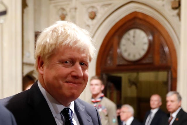 Prime Minister Boris Johnson walks back through the Peers Lobby after the State Opening of Parliament