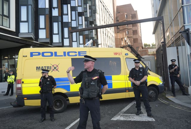 Police officers and a police van block the vehicle entrance at Liverpool Magistrates’ Court