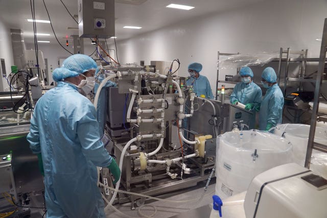 Staff work in a laboratory before a visit by Foreign Secretary Dominic Raab