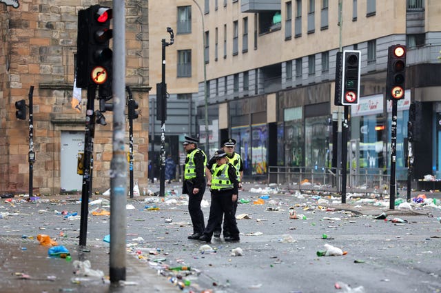 Police officers on the streets of Glasgow after Celtic won the William Hill Premiership title after a 3-1 win at home to Hearts
