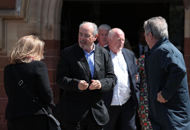 Drummer Paul Burgess (centre) from the band Ruefrex, leaves St Mark’s Church