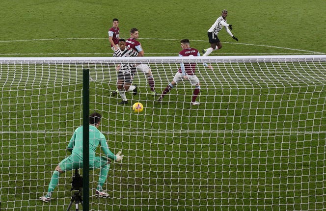 Paul Pogba, top, turns away in anticipation as his volley deflects off Matt Lowton, second right, for the only goal