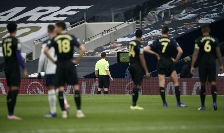 Peter Bankes checks the pitch side monitor at Tottenham