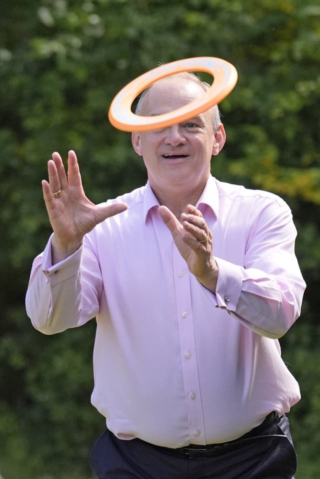 Liberal Democrats leader Sir Ed Davey plays with a frisbee