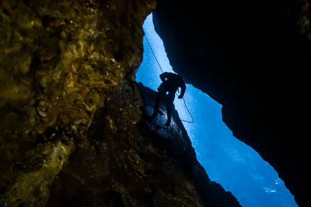 A potholer abseils into Gaping Gill