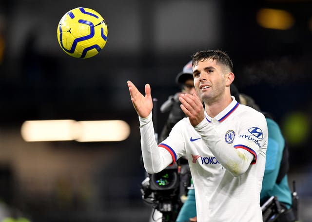 Christian Pulisic celebrates with the matchball after his hat-trick against Burnley