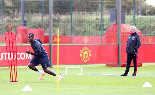 Paul Pogba (left) trains under the watchful eye of manager Jose Mourinho (Martin Rickett/PA).