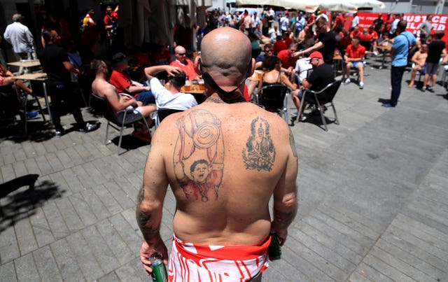A Liverpool fan poses for a picture in Madrid