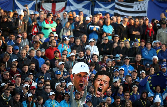 Fans hold up masks off Team Europe's Rory McIlroy and Sergio Garcia during the opening Fourballs match