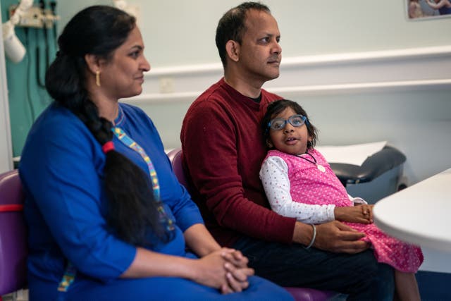 Aditi, eight, with father Uday and mother Divya