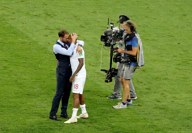 Southgate comforts Ashley Young after the defeat to Croatia