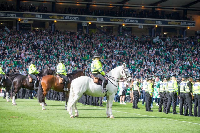 Police patrol the Hampden Park pitch