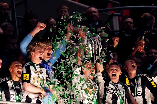 Newcastle’s Bruno Guimaraes and Kieran Trippier hold aloft the Carabao Cup after victory over Liverpool at Wembley