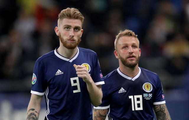 Scotland's Oliver McBurnie, left, and Johnny Russell, right, appear in shock