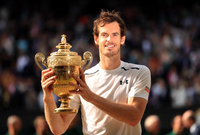 Andy Murray holds the Wimbledon trophy for the second time