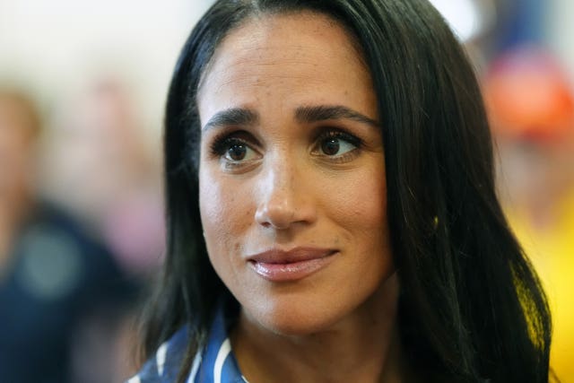 The Duchess of Sussex smiles at the camera