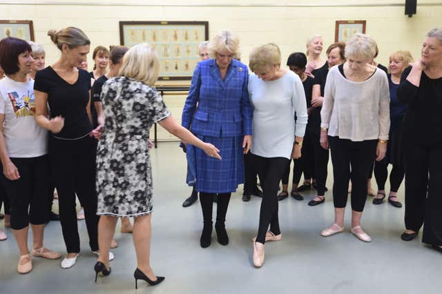 The Duchess of Cornwall with Elaine Paige and Angela Rippon as Camilla learns to do a tendu at the Royal Academy of Dance in London (Eddie Mulholland/Daily Telegraph/PA)