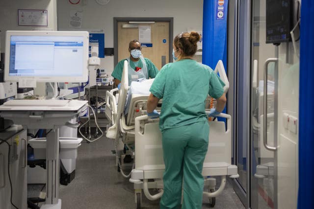 Staff nurses transfer a patient through the Emergency Department 