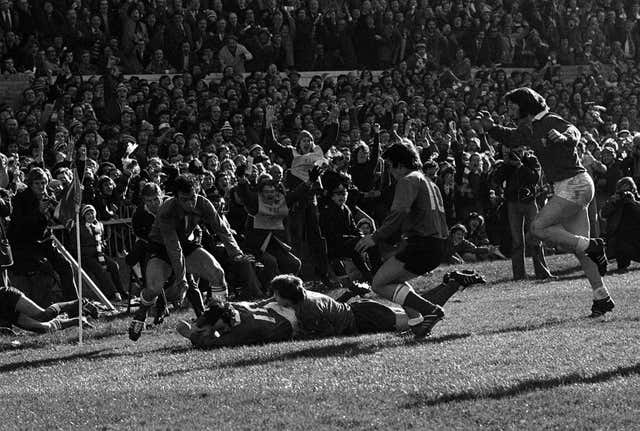 Phil Bennett (right, on the ground) scores a try for Wales against France in the Five Nations