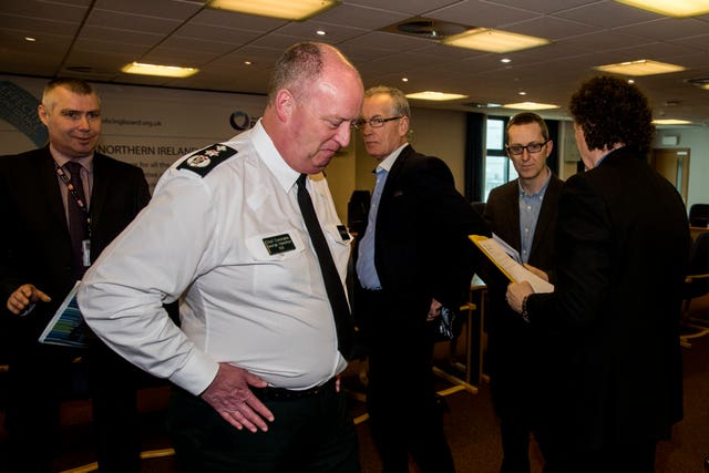PSNI Chief Constable George Hamilton, second from left, and Sinn Fein Policing Board member Gerry Kelly, centre