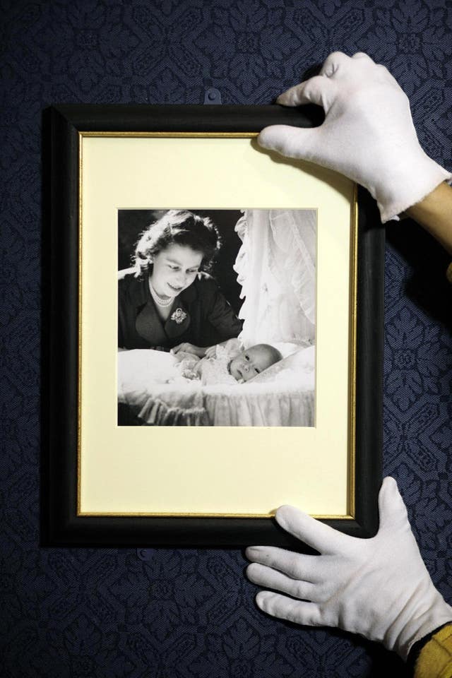 An exhibition showing Cecil Beaton’s photograph of Princess Elizabeth with her first child Prince Charles (Edmond Terakopian/PA) 