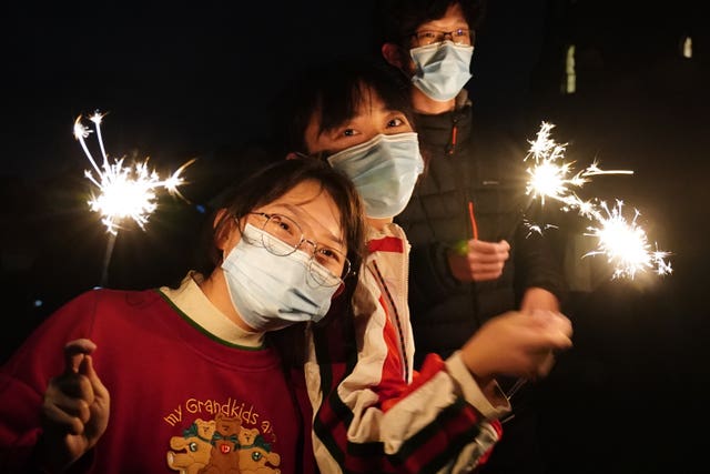 Visitors from China celebrate on Calton Hill