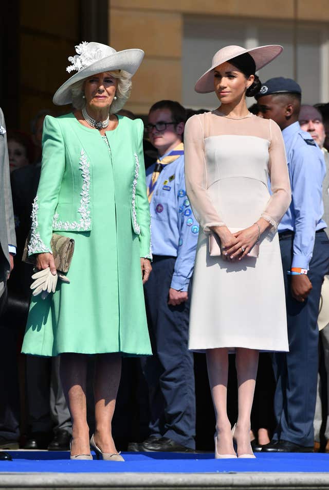 The Duchess of Cornwall (left) the Duchess of Sussex at a garden party at Buckingham Palace in London which she is attending as her first royal engagement after being married.