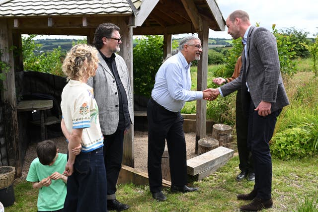 The Prince of Wales meets locals during a visit to the Apricot Centre