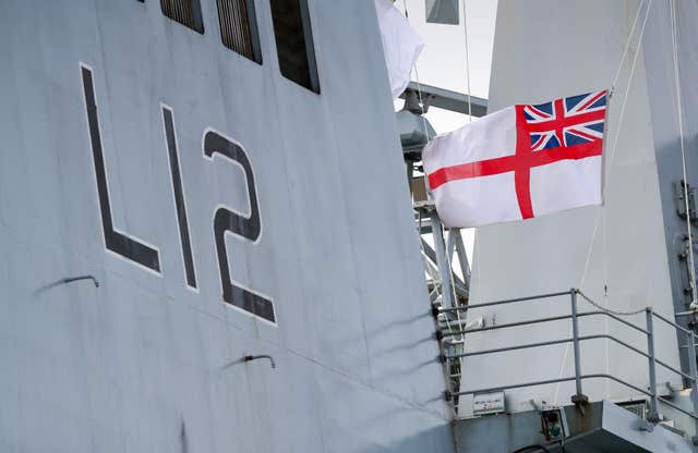 The Ensign is lowered at the decommissioning ceremony for HMS Ocean (Andrew Matthews/PA)