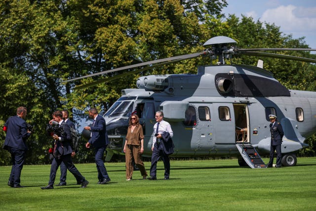 Then-UK Prime Minister Sir Keir Starmer and his wife Lady Victoria Starmer walk from their helicopter to the leader’s dinner during the G7 summit in Evian-les-Bains
