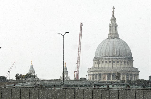 Commuters walking in the snow on London Bridge (Steve Parsons/PA)