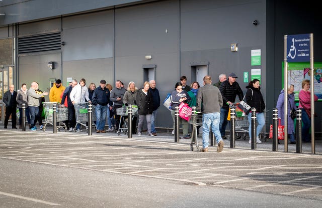 Shoppers queue outside an Asda Superstore at Straiton, Edinburgh