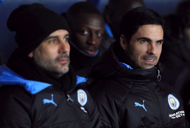 Manchester City manager Pep Guardiola with then assistant Mikel Arteta (right) 