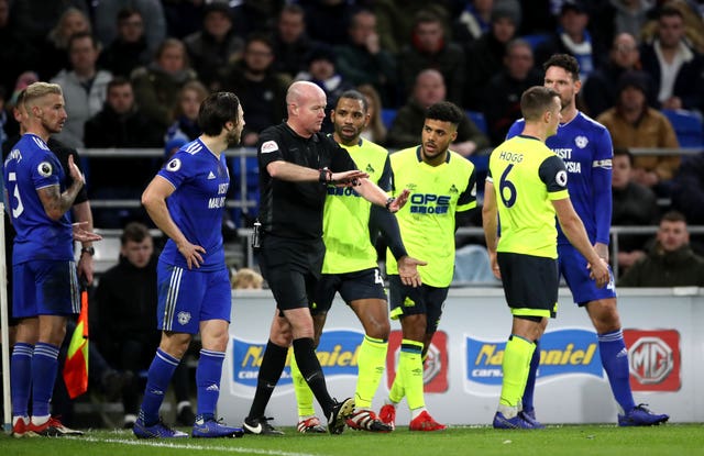 Referee Lee Mason overturns the penalty award to Huddersfield in their match at Cardiff (Nick Potts/PA).