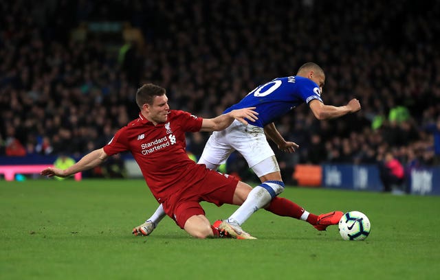 James Milner, left, tackles Everton's Richarlison