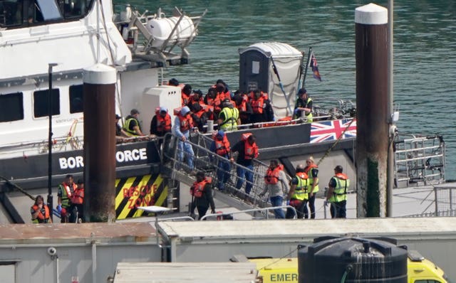 A group of people thought to be migrants are brought in to the Border Security Command compound in Dover, Kent, on Thursday