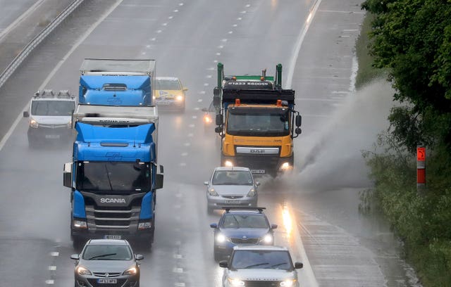 A lorry passes through a large puddle on the M20 in Ashford, Kent