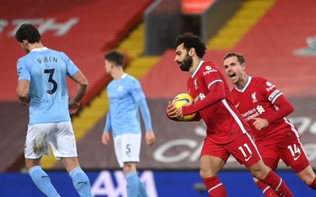 Mohamed Salah, second right, celebrates in muted fashion after scoring in Liverpool's defeat to Manchester City