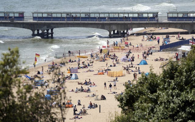 View of sunbathers on a beach in fine weather