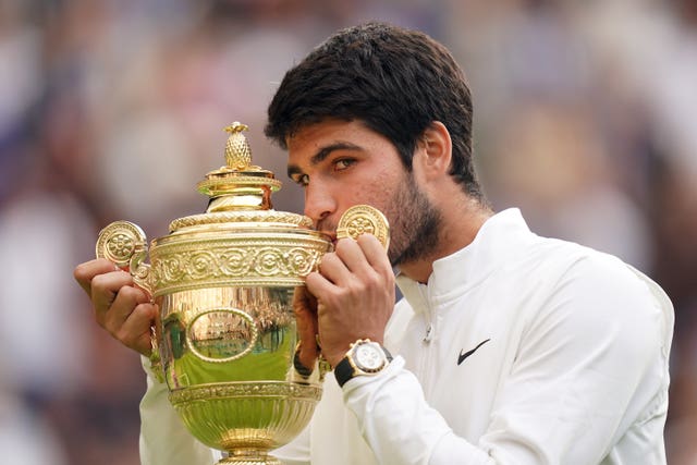 Carlos Alcaraz celebrates with the Wimbledon trophy
