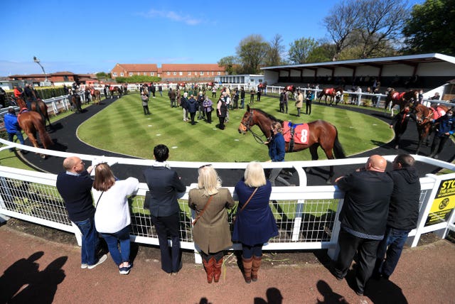Racegoers inspect the parade ring at Redcar Racecourse