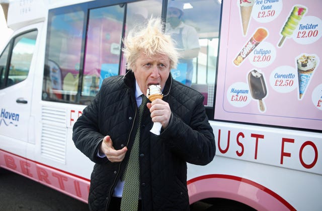 Prime Minister Boris Johnson eats an ice cream during a visit to Haven Perran Sands Holiday Park in Perranporth, Cornwall