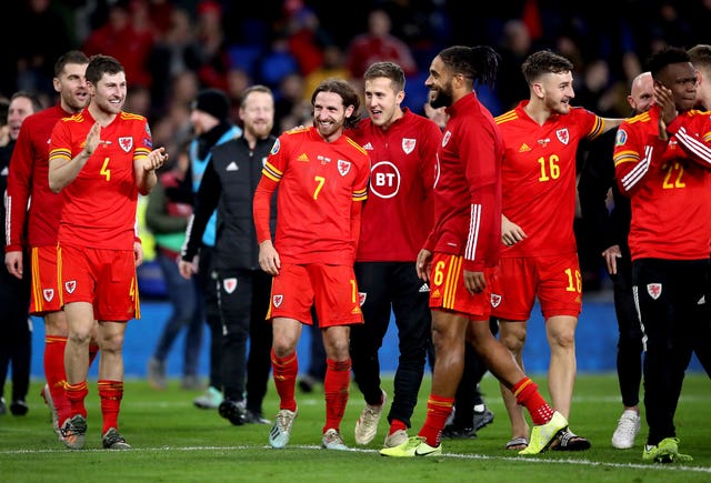 Wales players celebrate after securing qualification with a win over Hungary