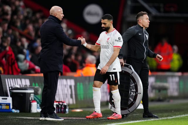 Liverpool manager Arne Slot (left) shakes hands with Mohamed Salah