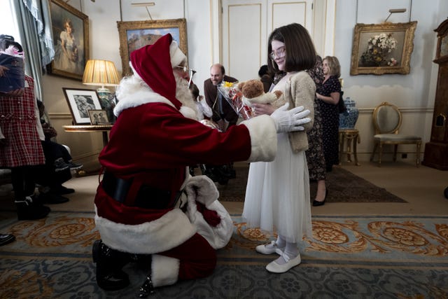 Santa speaks to a girl at Clarence House