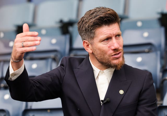 Sebastien Pocognoli talks in the Hampden stand