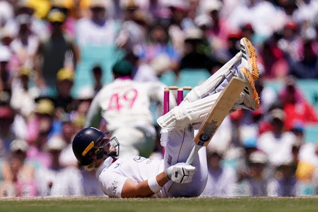 Jacob Bethell falls to the floor after being hit on the head by the bal