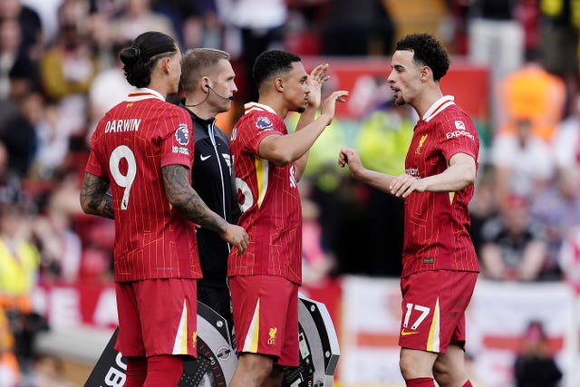 Trent Alexander-Arnold (centre) embraces Curtis Jones (right) as he replaces Conor Bradley